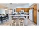 Well-equipped kitchen offering bar seating, adjacent to a dining area for convenient meals at 1633 Broken Feather Dr, North Las Vegas, NV 89031