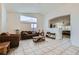 Bright living room with vaulted ceiling and large windows, features tile flooring and comfortable seating at 1633 Broken Feather Dr, North Las Vegas, NV 89031
