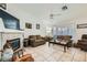 Bright living room with vaulted ceilings, cozy fireplace, and neutral tile flooring throughout at 1633 Broken Feather Dr, North Las Vegas, NV 89031