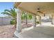 This patio has fans, textured columns, and overlooks a backyard with desert landscaping at 1633 Broken Feather Dr, North Las Vegas, NV 89031