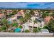 Expansive aerial view of a desert home, showcasing the backyard pool and solar panels, with mountain views at 2073 Sapphire Valley Ave, Henderson, NV 89074