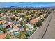 Expansive aerial view of a neighborhood featuring single Gathering homes, mature landscaping, and mountain views at 2073 Sapphire Valley Ave, Henderson, NV 89074