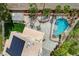 Aerial view showcasing backyard with pool, lush landscaping, cabana, and home with solar panels at 2073 Sapphire Valley Ave, Henderson, NV 89074