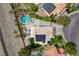 Overhead view of desert home featuring a pool and solar panels, surrounded by palm trees at 2073 Sapphire Valley Ave, Henderson, NV 89074