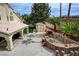 Backyard with a built in grill, bar and covered seating area with sport court and manicured lawn at 2073 Sapphire Valley Ave, Henderson, NV 89074