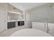 Bright bathroom featuring dual vanities and glass enclosed shower with shiplap and marble accents at 2073 Sapphire Valley Ave, Henderson, NV 89074