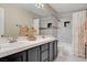 Bathroom with double sinks, tile shower, and neutral-colored walls at 2073 Sapphire Valley Ave, Henderson, NV 89074