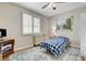 Comfortable bedroom with hardwood floors, ceiling fan, and a large window for natural light at 2073 Sapphire Valley Ave, Henderson, NV 89074