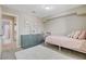 Bedroom featuring a light pink bed, neutral walls, and an en suite bathroom at 2073 Sapphire Valley Ave, Henderson, NV 89074