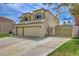 Charming home featuring a manicured lawn, mature trees, and a convenient two-car garage and gated driveway at 2073 Sapphire Valley Ave, Henderson, NV 89074