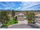 Inviting two-story home with a two-car garage, lush front lawn, and well-kept desert landscaping in the front yard at 2073 Sapphire Valley Ave, Henderson, NV 89074