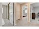 Hallway with carpeted floors leading to a mirrored closet, bedroom, and storage cabinets at 2073 Sapphire Valley Ave, Henderson, NV 89074