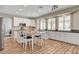 Modern kitchen features white cabinets, an island, and view of the back yard at 2073 Sapphire Valley Ave, Henderson, NV 89074