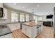Open kitchen with stainless appliances, white cabinets, and an island with seating at 2073 Sapphire Valley Ave, Henderson, NV 89074
