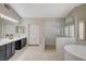 Main bathroom with dual sinks, walk-in shower, and soaking tub at 2073 Sapphire Valley Ave, Henderson, NV 89074