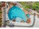 Aerial view of a backyard pool with rock features, surrounded by patio and green landscaping at 2073 Sapphire Valley Ave, Henderson, NV 89074