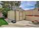 A storage shed with a basketball hoop in a well-kept backyard at 2073 Sapphire Valley Ave, Henderson, NV 89074
