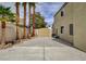 Spacious backyard area featuring tall palm trees, block wall, and wide driveway at 2073 Sapphire Valley Ave, Henderson, NV 89074