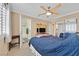 Comfortable bedroom with a ceiling fan, mirrored closet, and an adjoining bathroom with a shower at 2324 Babcock Dr, Las Vegas, NV 89134