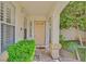 Inviting front entryway with covered porch, textured column, and green foliage at 2324 Babcock Dr, Las Vegas, NV 89134