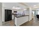 Modern kitchen features white cabinets, stainless steel appliances, and a black granite countertop bar at 2324 Babcock Dr, Las Vegas, NV 89134