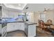 Well-lit kitchen with white cabinetry, granite countertops, stainless steel appliances, and adjacent dining area at 2324 Babcock Dr, Las Vegas, NV 89134