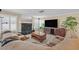 Open living area with fireplace, cozy seating, large TV, neutral walls and an abundance of natural light at 2324 Babcock Dr, Las Vegas, NV 89134