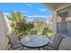 A covered patio is furnished with a table and chairs, offering a serene spot surrounded by lush landscaping at 2324 Babcock Dr, Las Vegas, NV 89134