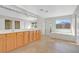 Bright bathroom with double sink vanity, tile floors, glass shower, and soaking tub at 24 Painted View St, Henderson, NV 89012