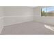 Neutral bedroom features a carpeted floor, neutral paint, and a bright window at 24 Painted View St, Henderson, NV 89012