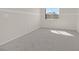 Neutral bedroom features a carpeted floor, neutral paint, and a bright window at 24 Painted View St, Henderson, NV 89012