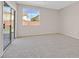 Carpeted bedroom featuring sliding glass doors and large windows, offering ample natural light at 24 Painted View St, Henderson, NV 89012