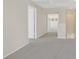 Hallway featuring neutral-toned carpet, natural light, and easy access to bedrooms at 24 Painted View St, Henderson, NV 89012