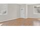 Bright living room with hardwood floors, neutral paint, and natural light from two windows at 24 Painted View St, Henderson, NV 89012