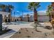 Backyard with a new pool, mature palm trees, and desert landscaping at 2685 S Tenaya Way, Las Vegas, NV 89117