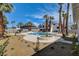 Expansive backyard with a sparkling pool, desert landscaping and a balcony creates a tranquil outdoor retreat at 2685 S Tenaya Way, Las Vegas, NV 89117