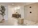 Modern bathroom featuring a sleek glass shower, dual vanities and neutral stone tiling at 2685 S Tenaya Way, Las Vegas, NV 89117