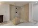 Modern bathroom featuring an open glass shower with bench seating and neutral stone tile at 2685 S Tenaya Way, Las Vegas, NV 89117