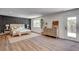 Modern bedroom with wood floors, statement wall, and access to the outdoors at 2685 S Tenaya Way, Las Vegas, NV 89117