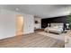 Well-designed bedroom features wood floors, accent wall, and inviting decor at 2685 S Tenaya Way, Las Vegas, NV 89117