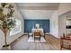 Bright dining area with wood floors, a statement wall, and large windows at 2685 S Tenaya Way, Las Vegas, NV 89117