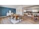 Bright dining area with wood floors, a statement wall, and direct access to the kitchen at 2685 S Tenaya Way, Las Vegas, NV 89117