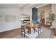 Bright dining room boasts modern table, accent wall, and open floor plan with wood flooring at 2685 S Tenaya Way, Las Vegas, NV 89117