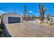 Long driveway with desert landscaping leading to a garage, showcasing the property's curb appeal at 2685 S Tenaya Way, Las Vegas, NV 89117