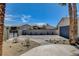 Long driveway with desert landscaping, garage and gated entrance creates a welcoming approach to the property at 2685 S Tenaya Way, Las Vegas, NV 89117