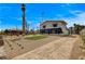 Spacious driveway and front yard with desert landscaping, palm trees, and gated entry at 2685 S Tenaya Way, Las Vegas, NV 89117