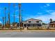 Charming two-story home boasting desert landscaping, a dark blue accent wall, and tall palm trees at 2685 S Tenaya Way, Las Vegas, NV 89117