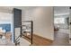 Hallway with open rail and views to dining room and a bedroom suite at 2685 S Tenaya Way, Las Vegas, NV 89117