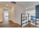 Upstairs hallway showcases wood flooring and an open view to the living area below at 2685 S Tenaya Way, Las Vegas, NV 89117