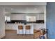 Modern kitchen with white cabinets, an island with bar seating, and black backsplash at 2685 S Tenaya Way, Las Vegas, NV 89117